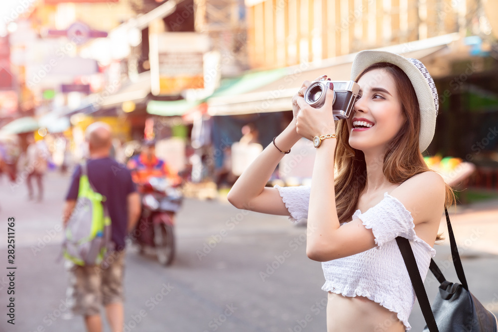 Young Asian traveling women traveling backpacker and take photo on holiday at Bangkok Thailand, traveler and tourist concept.