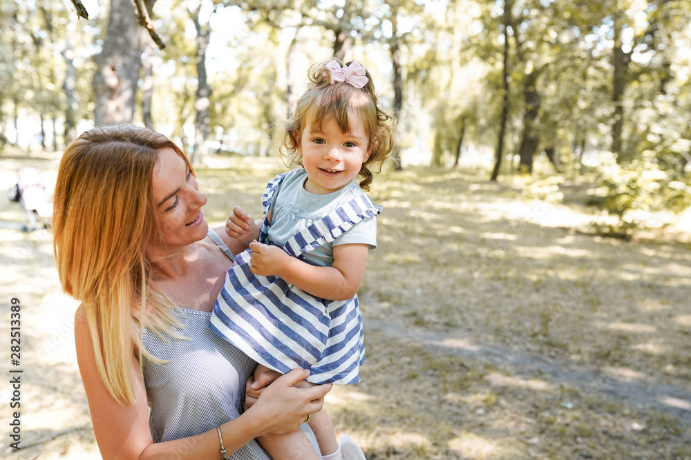 Mother and daughter having fun in the park. Happiness and harmony in family life. copy space Mother and daughter having fun in the park. Happiness and harmony in family life. copy space