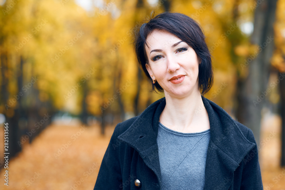 Beautiful woman posing in autumn city park, fall season, yellow leaves Beautiful woman posing in autumn city park, fall season, yellow leaves