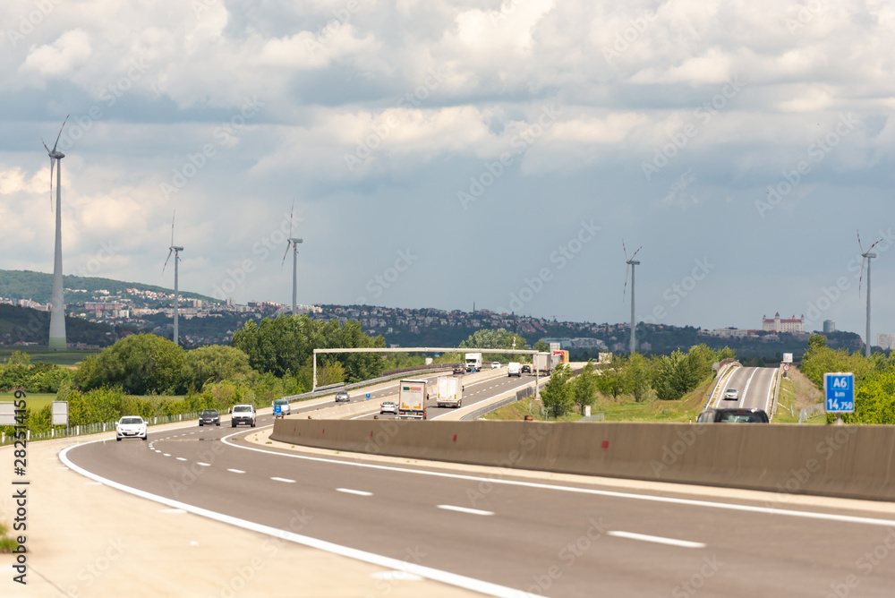 Fototapeta premium Roads Of Austria. View of Bratislava from Austria. Windmills along the road. Austria, may 2019/