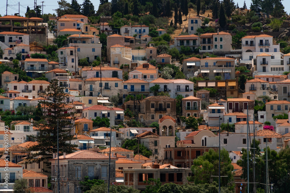 View to white houses with red roofs of Poros town, Saronic islands, Poros island, Greece. Pattern