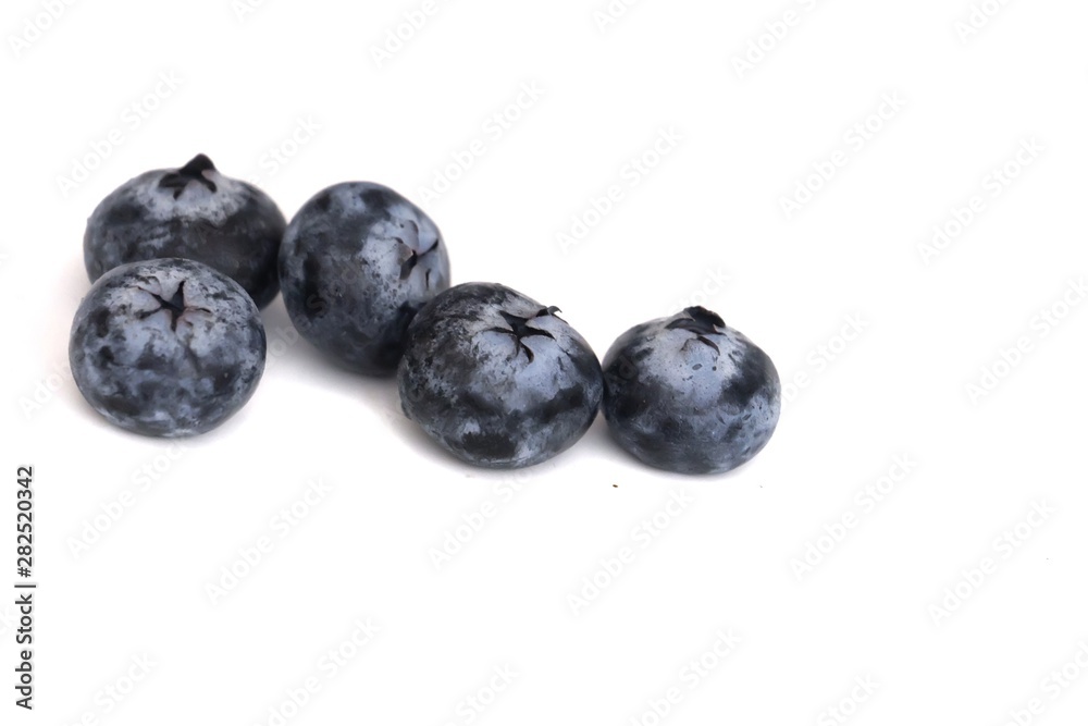 In selective focus a group of fresh blueberries on white isolated background In selective focus a group of fresh blueberries on white isolated background