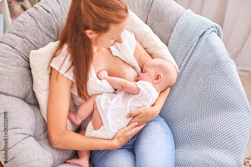 Breast feeding. Mum feeds the child. with free text space. copy space photo