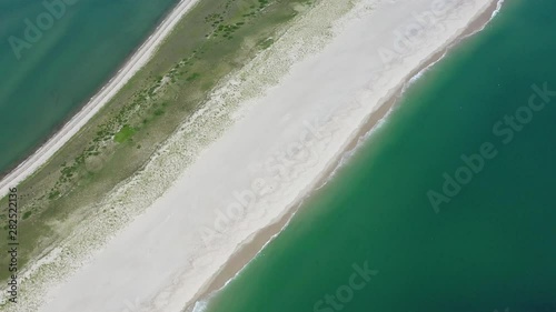 The nutrient-rich waters of the Atlantic Ocean bathe a scenic beach on Cape Cod, Massachusetts. This beautiful area of New England, not too far from Boston, is a popular summer vacation destination. photo