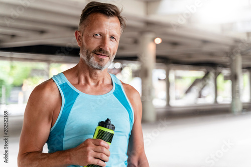 Sporty man with drinking bottle