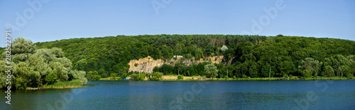Southern Bug River. District of the Sabarov hydroelectric station. Rock overgrown with dense forest. The inscription on the rock reads "Do not litter"