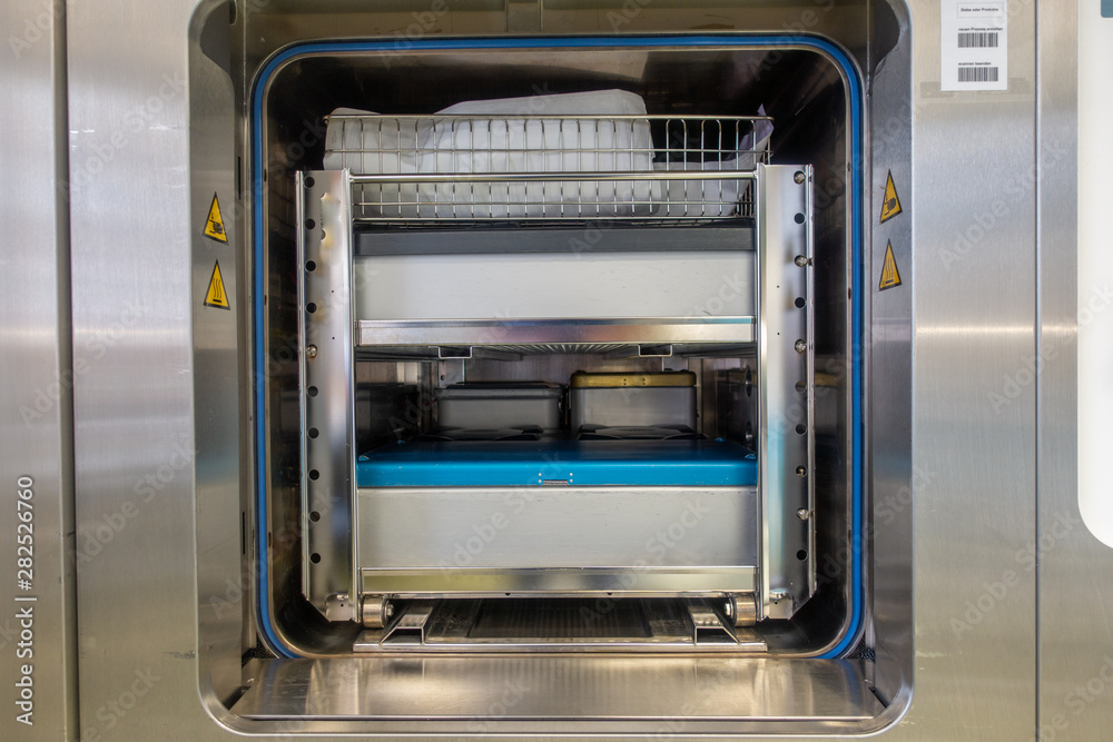 Fototapeta premium different instrument containers are pushed into a sterilization unit