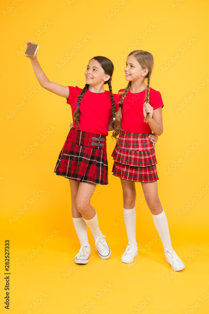 Taking selfie photo. Fashion blog. Blog online. Smartphone application concept. Blogger on social networks. Digital technology. Blogging modern trend. Personal blog. Children girls hold smartphone Taking selfie photo. Fashion blog. Blog online. Smartphone application concept. Blogger on social networks. Digital technology. Blogging modern trend. Personal blog. Children girls hold smartphone