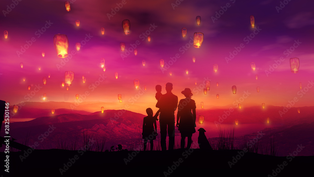 Family with children watching at flying Chinese lanterns at sunset