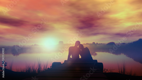 Loving couple sitting by the lake at sunset