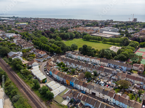 Aerial photo of the town of Worthing  large seaside town in England  and district with borough status in West Sussex  England UK  showing typical housing estates and businesses on a bright sunny day