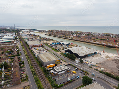 Aerial photo of the town of Shoreham-by-Sea, a seaside town and port in West Sussex, England UK, showing typical housing estates and businesses taken on a bright sunny day. photo