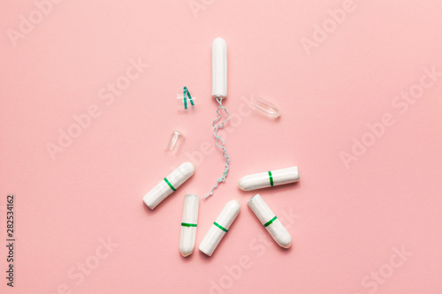 Unpacked tampons on a soft pink background. Modern female intimate gynecological hygiene. Eco zero waste concept. Copy spase place for text. Flat lay
