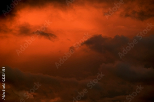 Intense orange sunset sky over Florida filled with storm clouds.