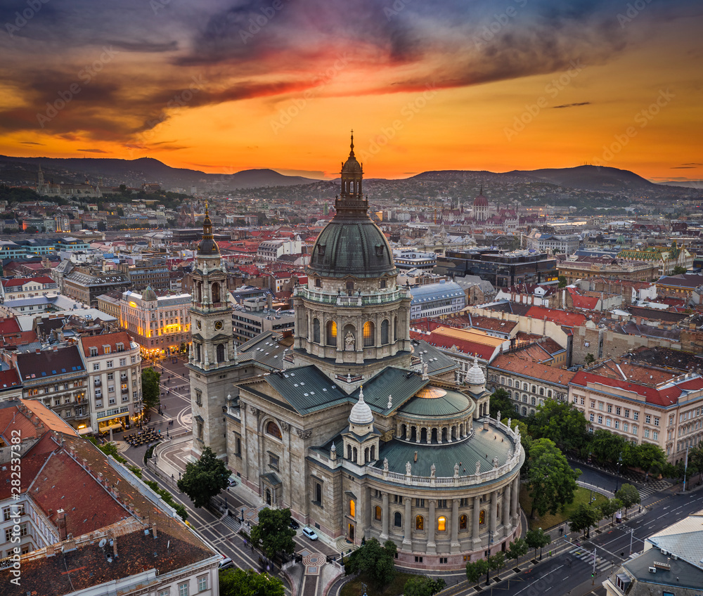 Budapest, Hungary - Aerial drone view of the beautiful St.Stephen's Basilica (Szent Istvan Bazilika) with a golden sunset. Parliament of Hungary and Fisherman's Bastion (Halaszbastya) at background