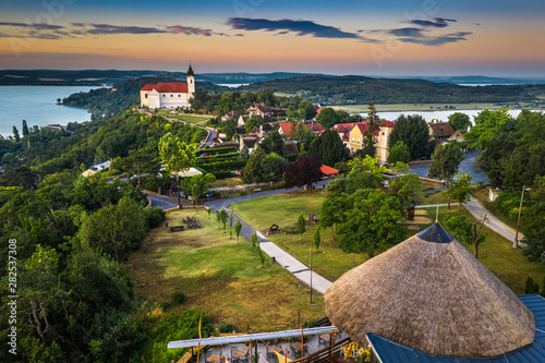 Tihany, Hungary - Panoramic view of the beautiful village of Tihany on the northern shore of Lake Balaton with the Benedictine Tihany Abbey (Tihanyi apatsag), Inner Lake and a colorful sky at sunrise photo