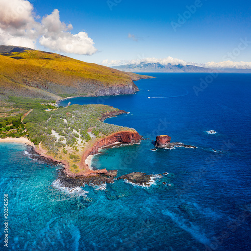 Aerial Drone view of Lāna'i Island, Hawaii, with Maui looming in the background.