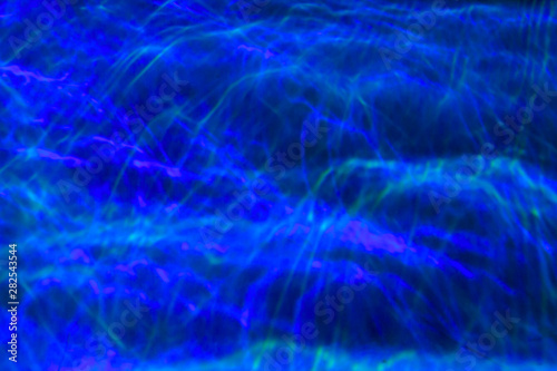 the particle motion of the line neon, deep blue background