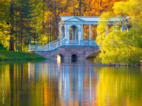 Russia. The Suburbs Of St. Petersburg. Pushkin. Tsarskoe selo. Autumn park. St. Petersburg in autumn. Autumn landscape. A bridge over the canal and trees with yellow leaves. nature of Russia.