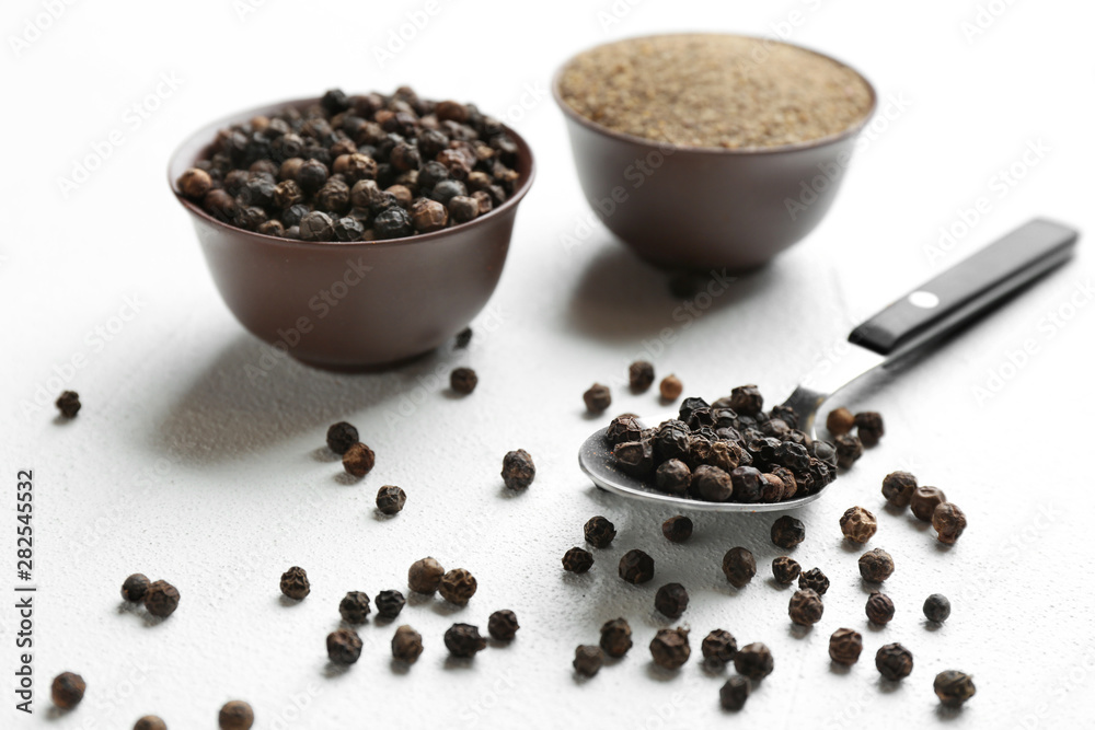 Ground black pepper and corns on light table Ground black pepper and corns on light table
