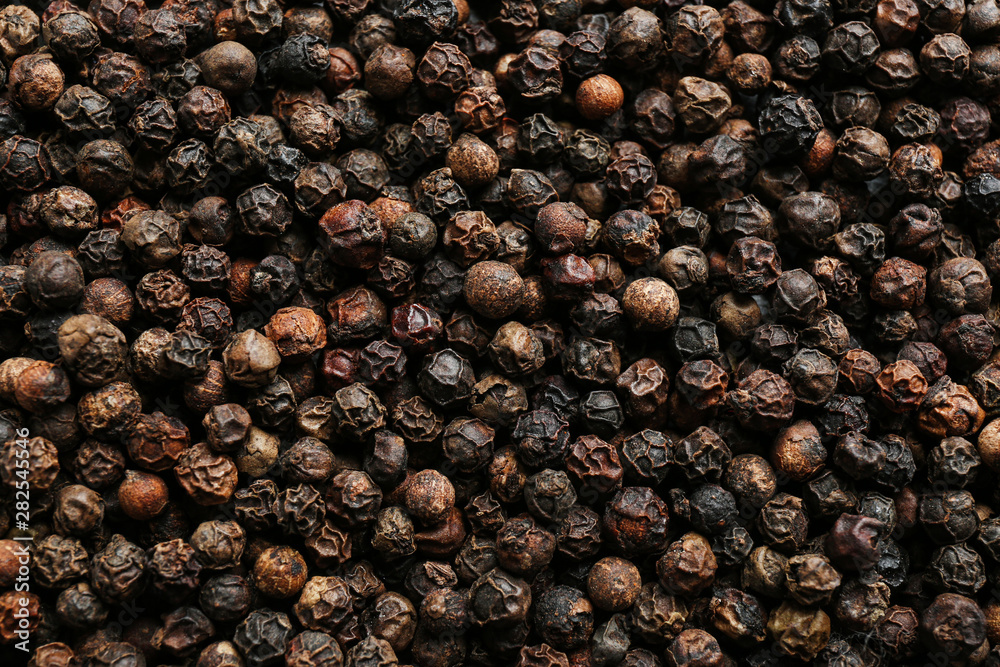 Many black peppercorns as background, top view