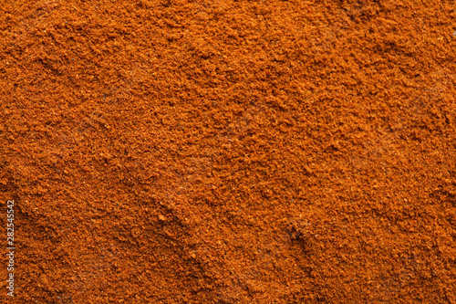 Ground red pepper as background, top view