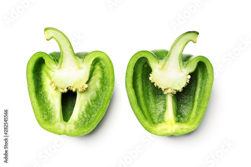 Halves of green bell pepper on white background, top view