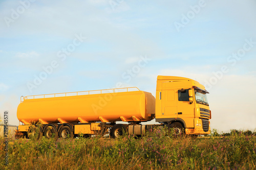 Modern yellow truck parked on country road