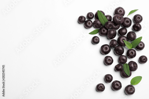 Fresh acai berries on white background, top view photo