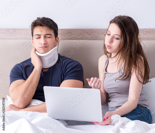 Loving wife taking care of injured husband in bed