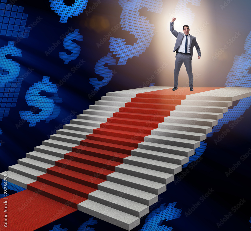 Young businessman climbing stairs and red carpet Young businessman climbing stairs and red carpet