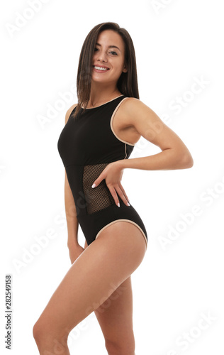 Pretty sexy woman with slim body in stylish black bikini on white background