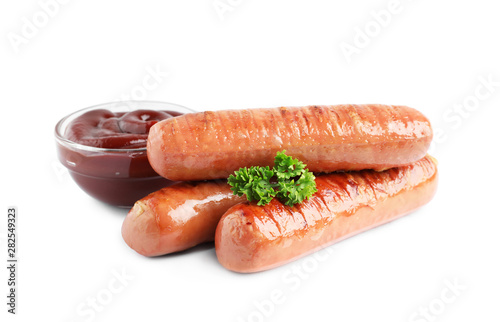 Delicious grilled sausages and sauce on white background. Barbecue food