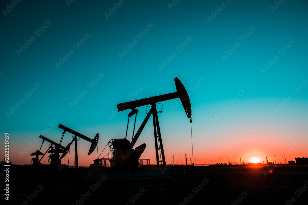 In the evening oil field, the pump is running.