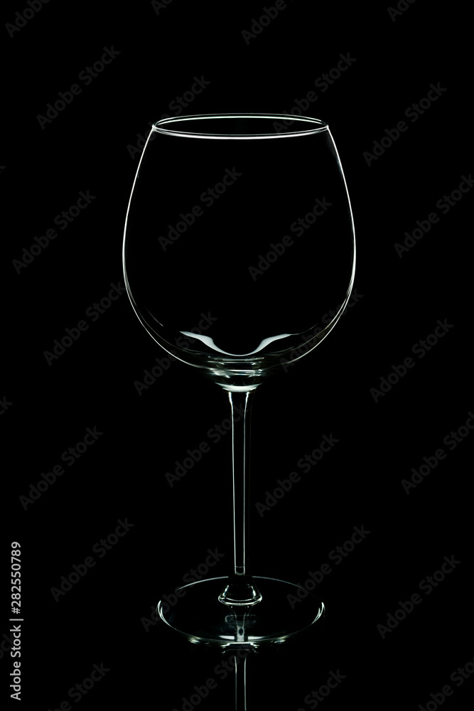 Elegant silhouette empty wine glass isolated on black background. Alcohol drinking concept. Elegant silhouette empty wine glass isolated on black background. Alcohol drinking concept.