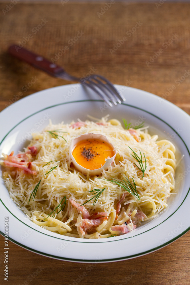 Pasta carbonara. Creamy Spaghetti Carbonara. Italian cuisine dish. View from above, top studio shot Pasta carbonara. Creamy Spaghetti Carbonara. Italian cuisine dish. View from above, top studio shot