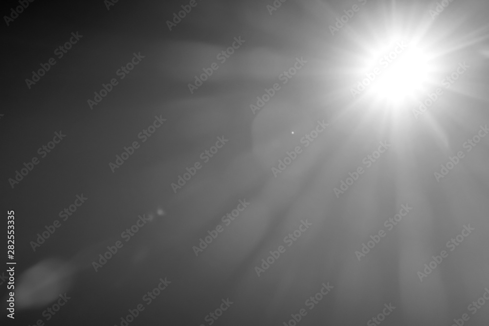 Abstract Black and white background of sun rays light effects and lens flare for over lay design. White glowing light burst on transparent background. Spotlights scene light effects. Copy space.
