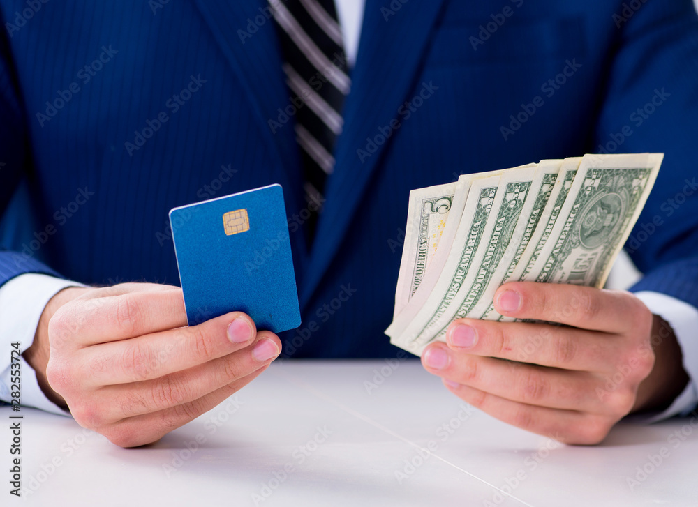 Businessman holding dollar money and credit card