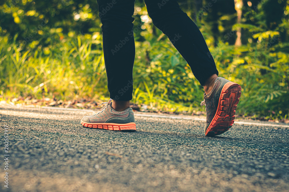 Close up foot women run feet on road in workout wellness.