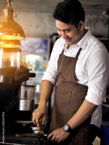 Happy Asian barista man working in cafe  lifestyle concept.