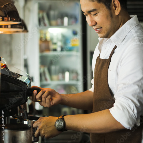 Happy Asian barista man working in cafe, lifestyle concept.