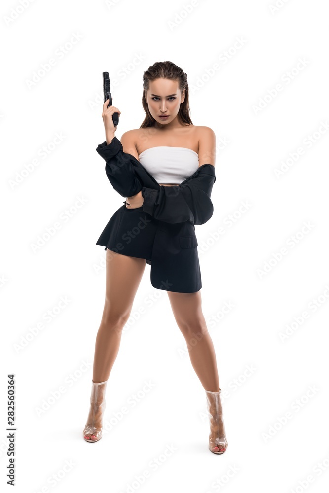 Confident seductive woman in black jacket with gun Confident seductive woman in black jacket with gun