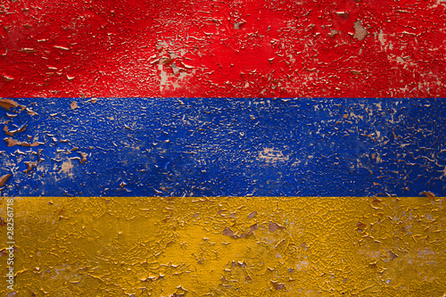 National flag of Armenia on old peeling wall background.The concept of national pride and symbol of the country.