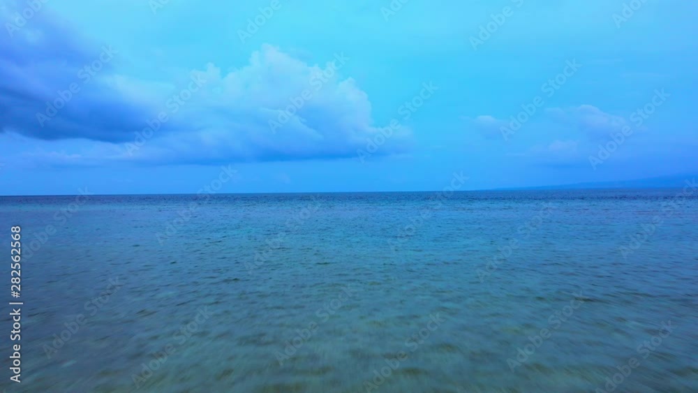 Aerial Forward: Blue Ocean Water, Puffy Clouds Overhead - Gili Islands, Bali Aerial Forward: Blue Ocean Water, Puffy Clouds Overhead - Gili Islands, Bali