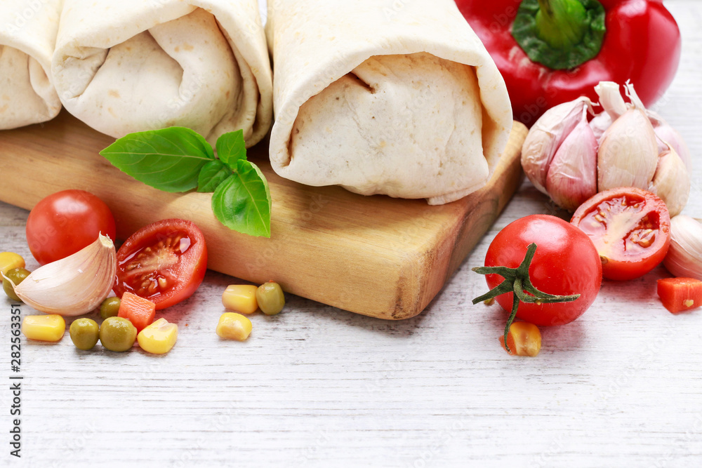 A burrito - mexican dish that consists of a flour tortilla with various ingredients. A burrito - mexican dish that consists of a flour tortilla with various ingredients.