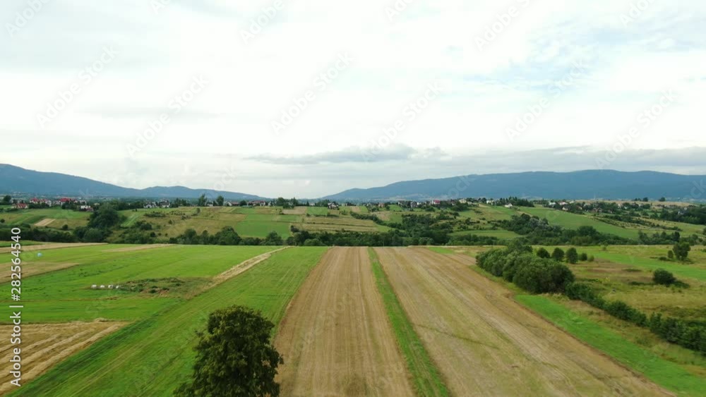 Aerial shot of fields with mountains in the background cloudy day. Aerial shot of fields with mountains in the background cloudy day.