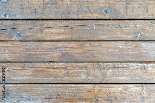 Old gray wooden panels. Granary board Peeled wood panels with gaps between them. Background.
