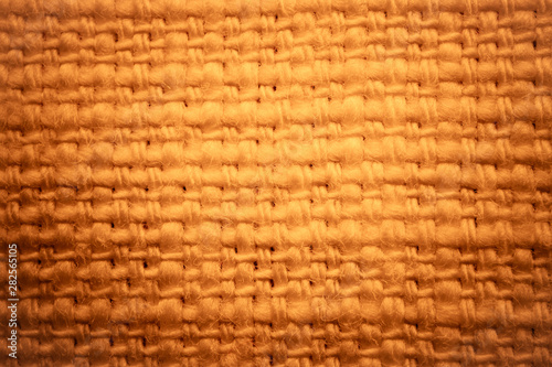 Close up fabric texture for background. Golden tones.