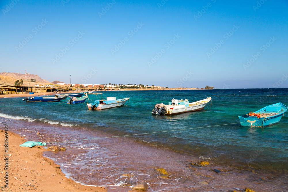 fishing boat anchored at shore in the red sea 
