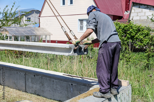 Installing concrete slabs at a construction site at home